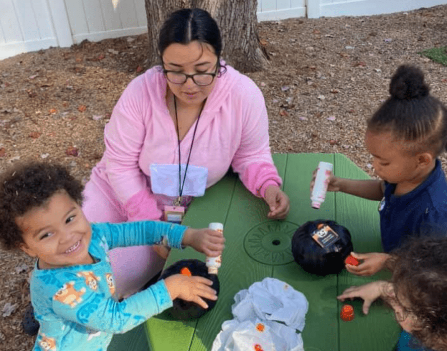 2 year old students playing with their teacher