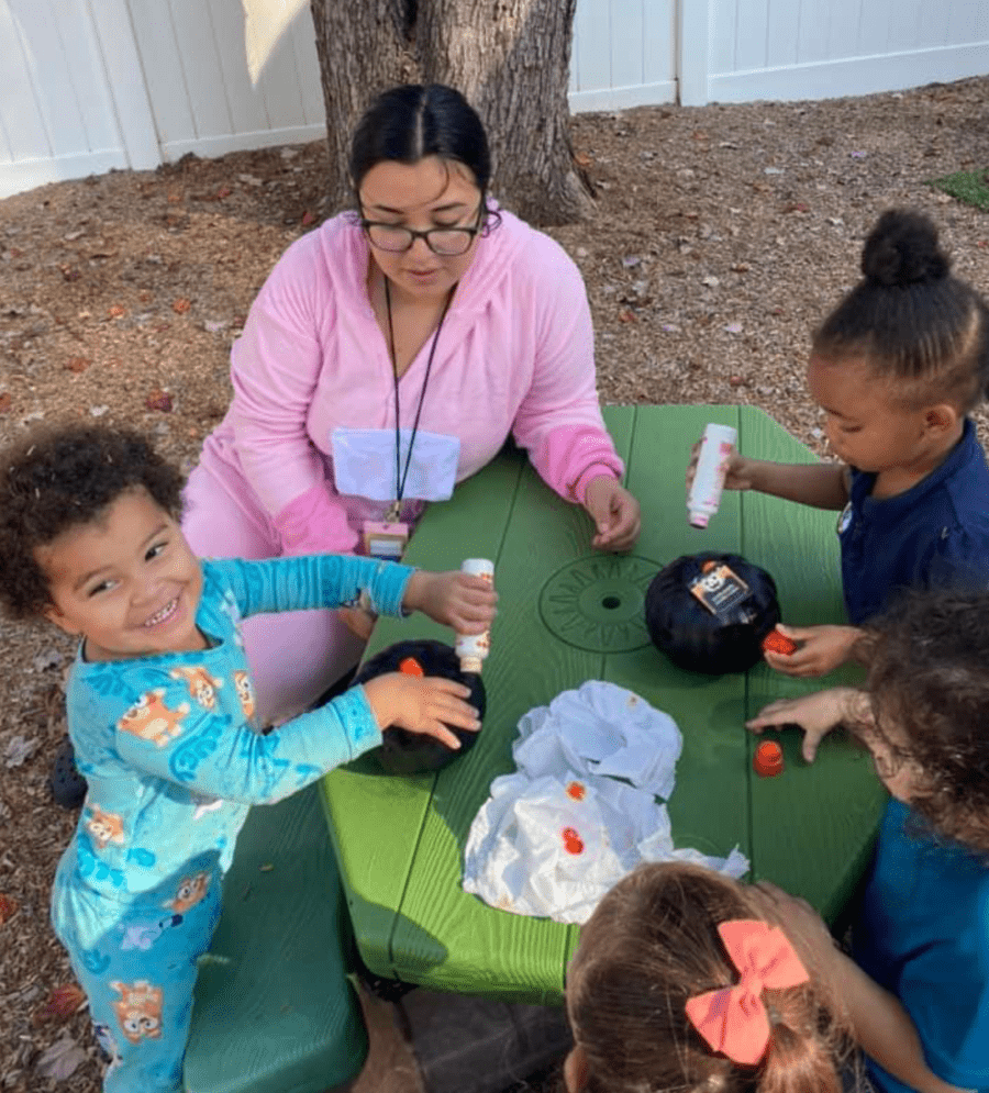 2 year old students playing with their teacher