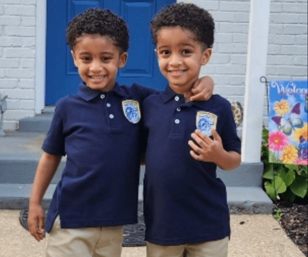 Twins in uniform on the first day of school